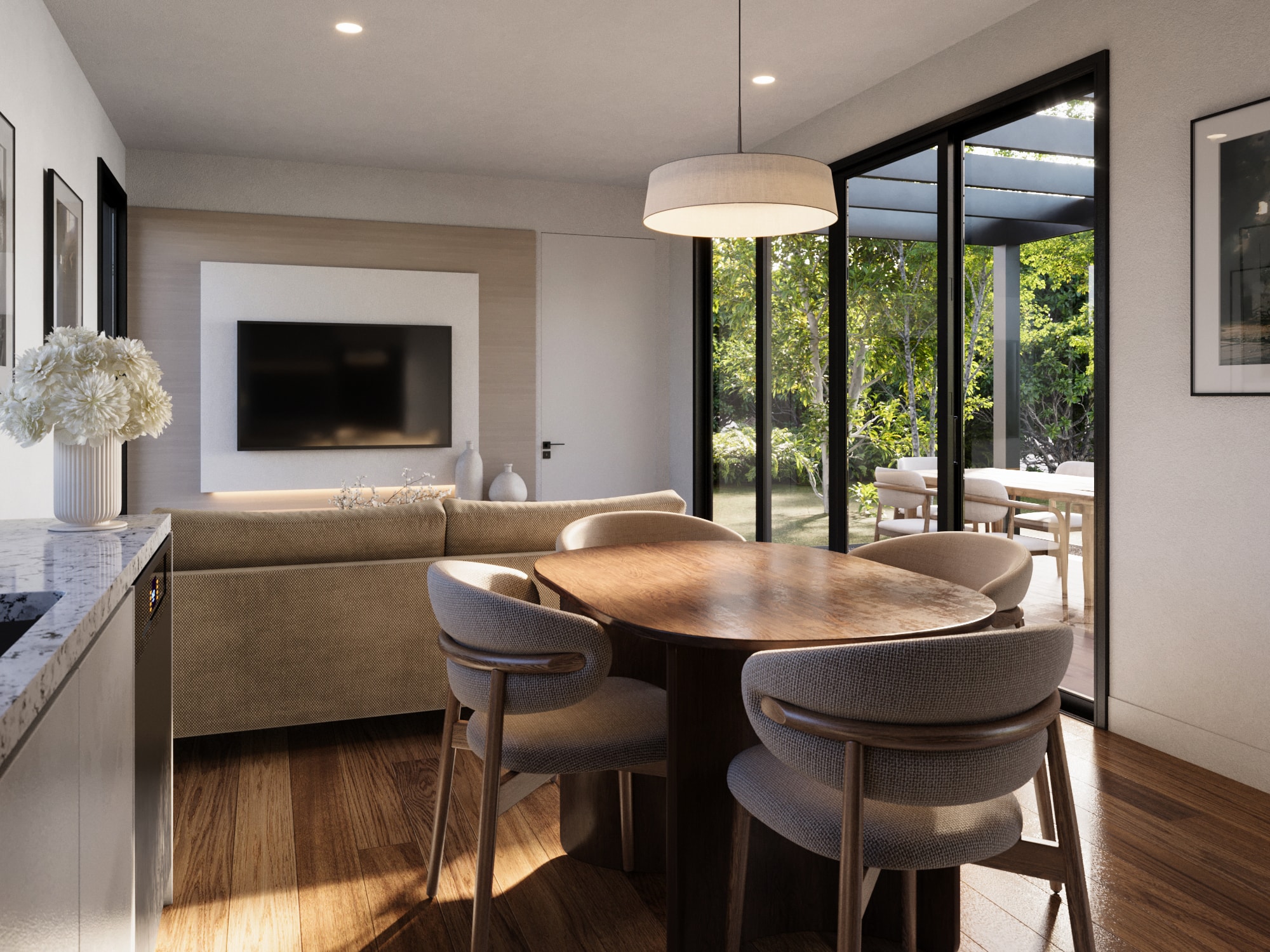 Kitchen and living in a Dwellix granny flat: timber floors, soft palette, framed garden views